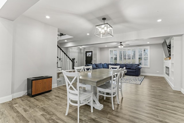 8081 Tennessee Ave, Willowbrook, IL 60527 - dining room featuring stairway, wood finished floors, a glass covered fireplace, recessed lighting, and baseboards