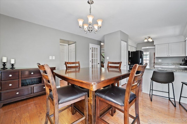 311 Mayfair Ln, South Elgin, IL 60177 - dining space with light wood finished floors, a chandelier, and french doors