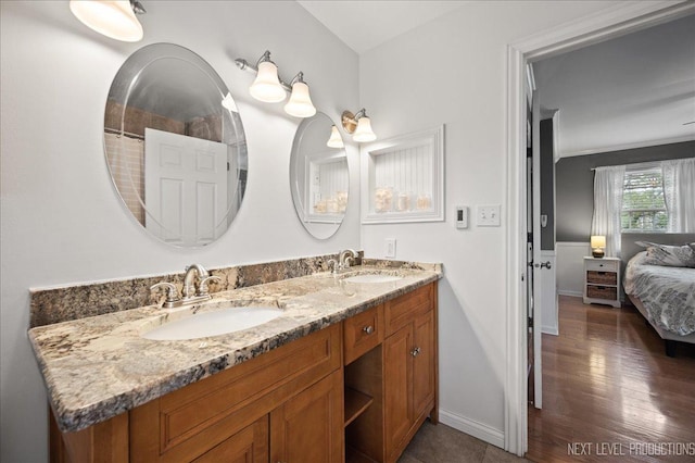 311 Mayfair Ln, South Elgin, IL 60177 - ensuite bathroom with double vanity, baseboards, and wood finished floors