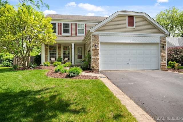 311 Mayfair Ln, South Elgin, IL 60177 - view of front of house with asphalt driveway, stone siding, a front yard, and an attached garage