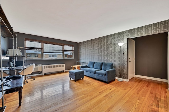 7435 N Ridge Blvd Unit 3B, Chicago, IL 60645 - living area featuring radiator, an accent wall, wood finished floors, an office area, and baseboards