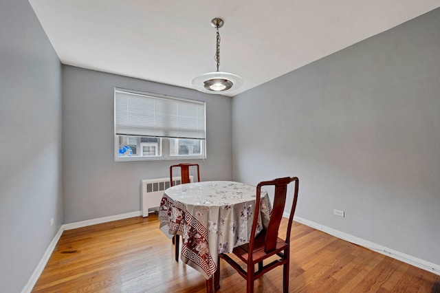 7435 N Ridge Blvd Unit 3B, Chicago, IL 60645 - dining room with radiator, light wood-style flooring, and baseboards