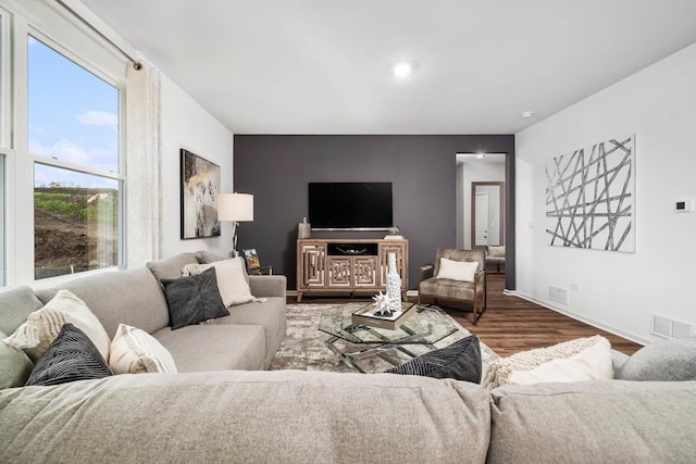 living area featuring wood finished floors and baseboards
