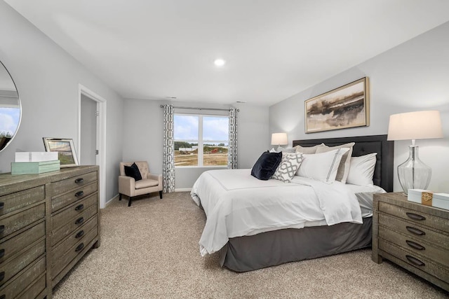bedroom featuring light colored carpet, recessed lighting, and baseboards