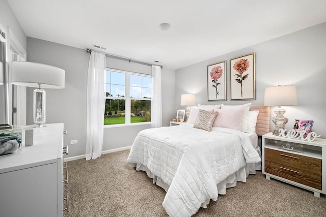 bedroom featuring light carpet and baseboards