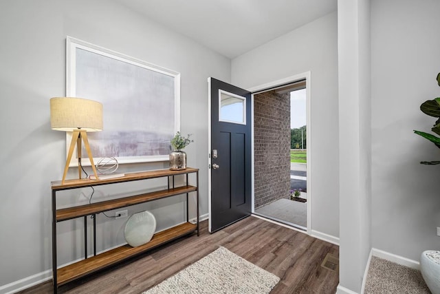 entryway featuring wood finished floors and baseboards