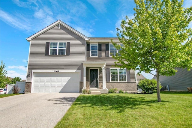6103 Winterhaven Dr, Joliet, IL 60431 - view of front facade featuring a garage, brick siding, a front yard, and driveway