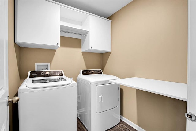6103 Winterhaven Dr, Joliet, IL 60431 - laundry room with cabinet space, separate washer and dryer, and dark wood-style flooring