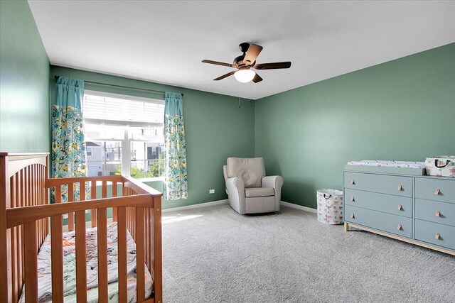 6103 Winterhaven Dr, Joliet, IL 60431 - carpeted bedroom with a crib, baseboards, and a ceiling fan
