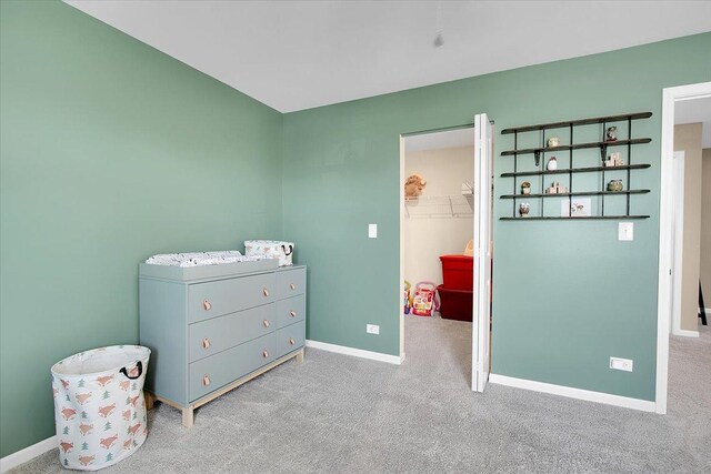 6103 Winterhaven Dr, Joliet, IL 60431 - carpeted bedroom featuring a walk in closet and baseboards