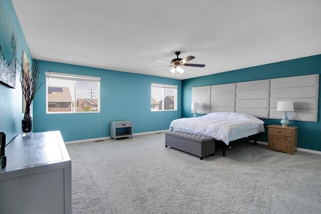 6103 Winterhaven Dr, Joliet, IL 60431 - carpeted bedroom featuring multiple windows, baseboards, and a ceiling fan