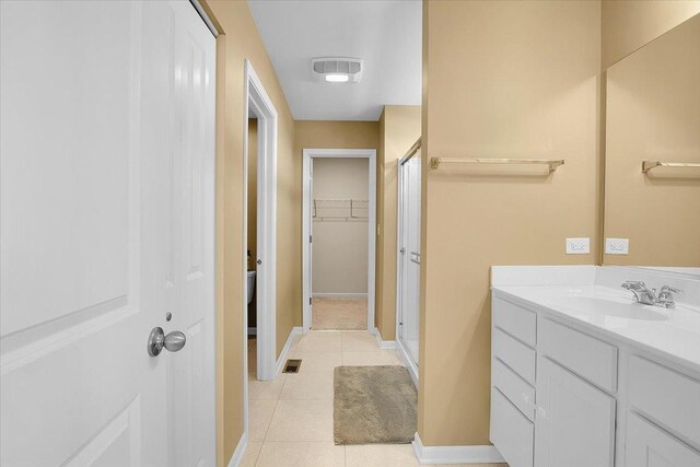 6103 Winterhaven Dr, Joliet, IL 60431 - bathroom featuring a shower stall, tile patterned flooring, vanity, and a spacious closet