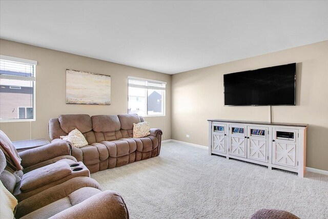 6103 Winterhaven Dr, Joliet, IL 60431 - carpeted living room with baseboards and plenty of natural light