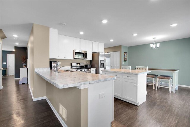 6103 Winterhaven Dr, Joliet, IL 60431 - kitchen with appliances with stainless steel finishes, a sink, light countertops, baseboards, and dark wood-style flooring