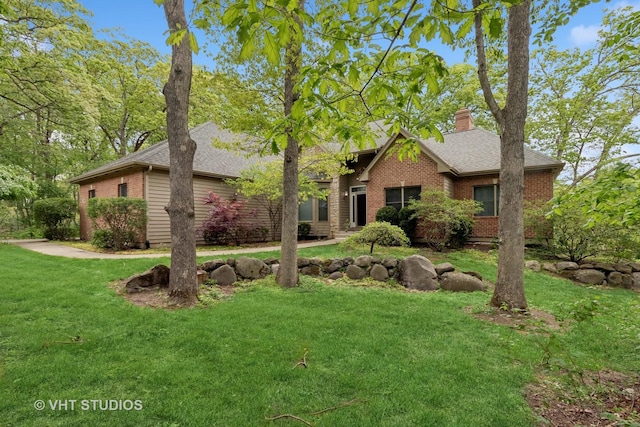 1302 Bradley Ct, Spring Grove, IL 60081 - view of front of property featuring brick siding, a chimney, a front lawn, and a shingled roof