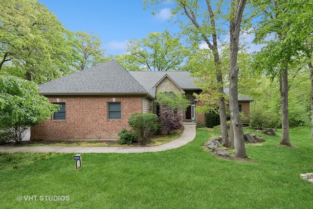 1302 Bradley Ct, Spring Grove, IL 60081 - view of front of house with a front lawn, a shingled roof, and brick siding