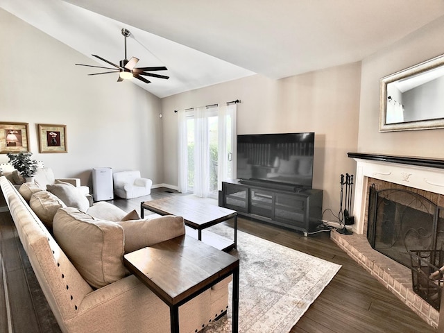 living area featuring dark wood-style flooring, a fireplace, a ceiling fan, baseboards, and high vaulted ceiling