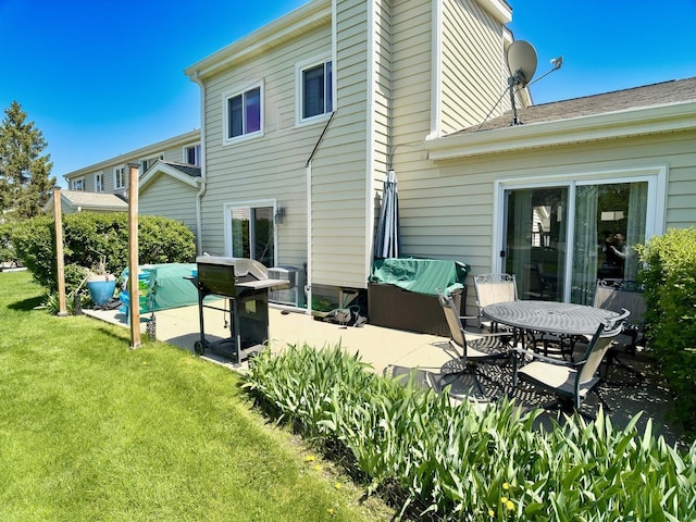 back of house featuring a patio and a yard