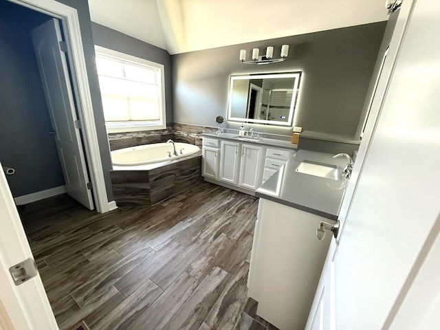 12074 Winterberry Ln, Plainfield, IL 60585 - full bathroom featuring a garden tub, double vanity, vaulted ceiling, wood finished floors, and a shower