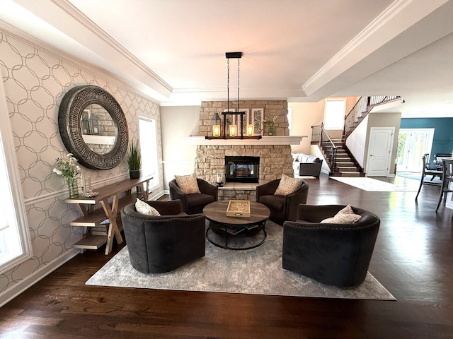 12074 Winterberry Ln, Plainfield, IL 60585 - living room featuring a stone fireplace, dark wood-type flooring, stairs, baseboards, and wallpapered walls