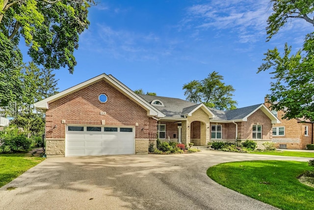 traditional-style house with concrete driveway, brick siding, and a garage