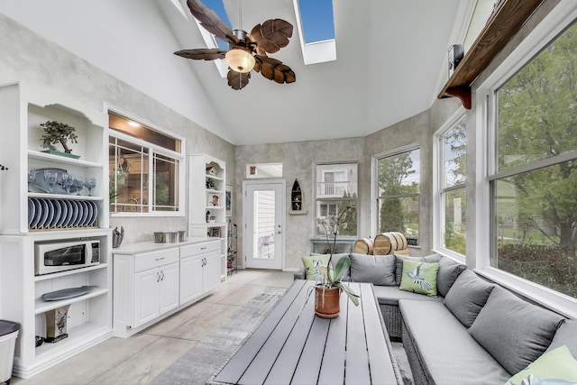 sunroom with lofted ceiling and a skylight