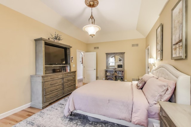 bedroom with light wood-style floors and baseboards