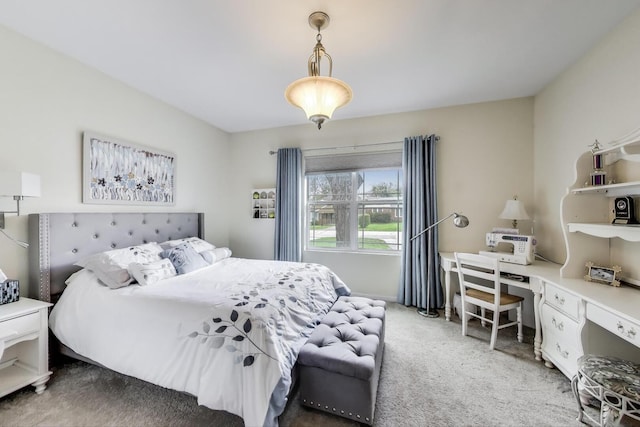bedroom with light colored carpet, a desk, and baseboards