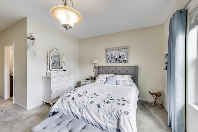 bedroom featuring light carpet and baseboards