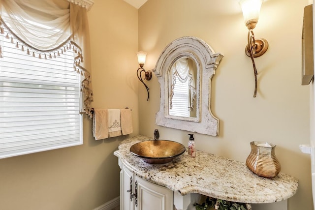 bathroom featuring vanity and baseboards