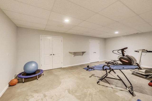 exercise area with a drop ceiling, baseboards, and recessed lighting