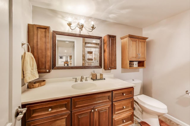 bathroom featuring toilet and vanity