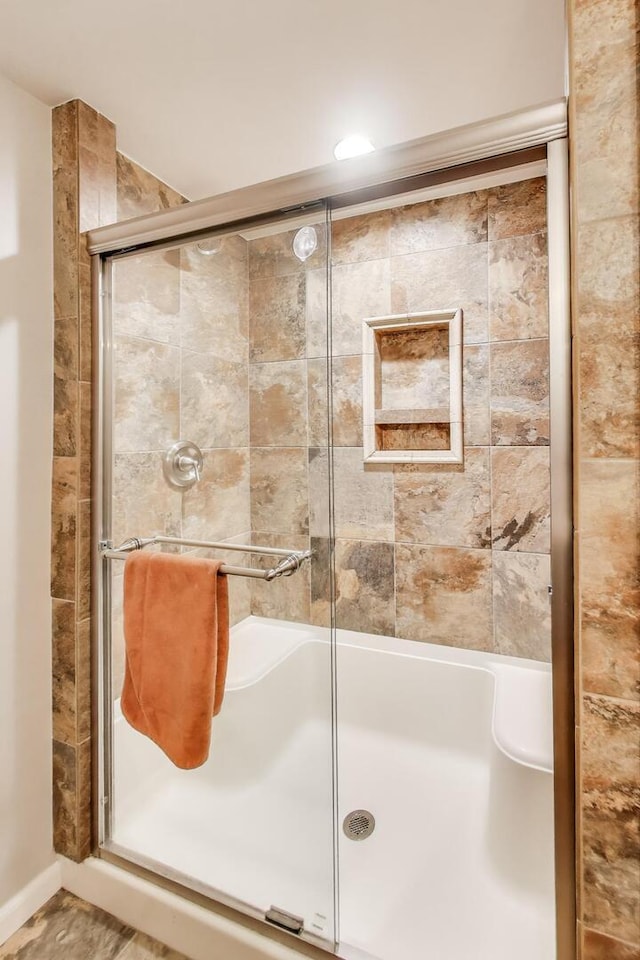 full bath with a shower stall