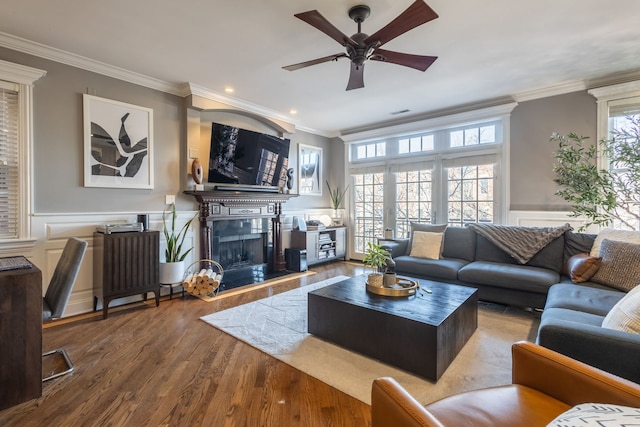 853 W Buckingham Pl Unit 4, Chicago, IL 60657 - living area featuring a fireplace with raised hearth, crown molding, a ceiling fan, wood finished floors, and a decorative wall