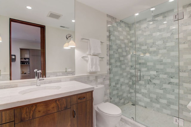 1942 N Cleveland Ave, Chicago, IL 60614 - full bathroom with a stall shower, toilet, vanity, tile walls, and recessed lighting