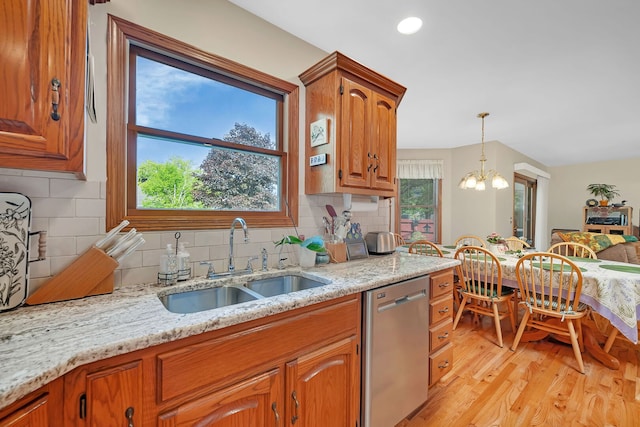 1002 Birchwood Ct, Morris, IL 60450 - kitchen with dishwasher, a sink, light wood-type flooring, light stone counters, and a chandelier