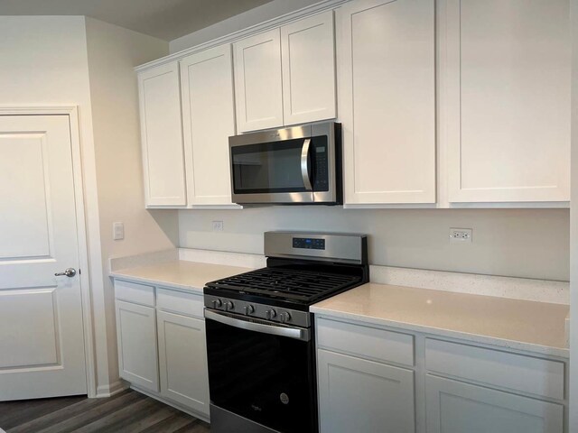 2611 Harnish Dr, Algonquin, IL 60102 - kitchen with stainless steel appliances, dark wood-style flooring, and white cabinetry