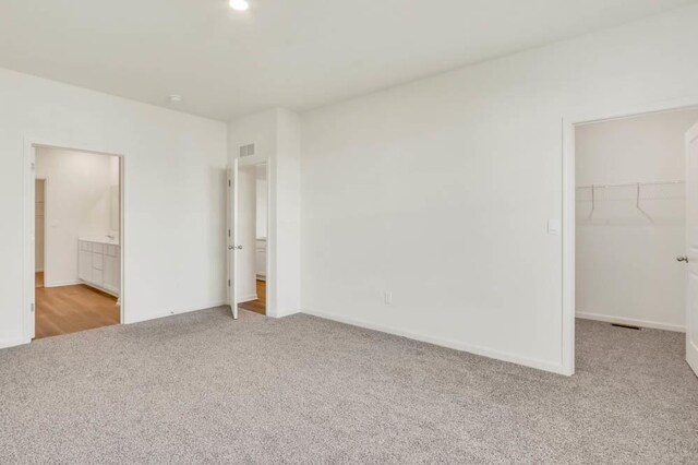2611 Harnish Dr, Algonquin, IL 60102 - unfurnished bedroom with carpet floors, a walk in closet, a closet, and baseboards