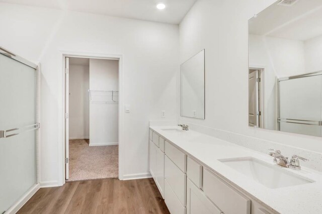 2611 Harnish Dr, Algonquin, IL 60102 - full bath with double vanity, wood finished floors, a shower with shower door, baseboards, and a spacious closet