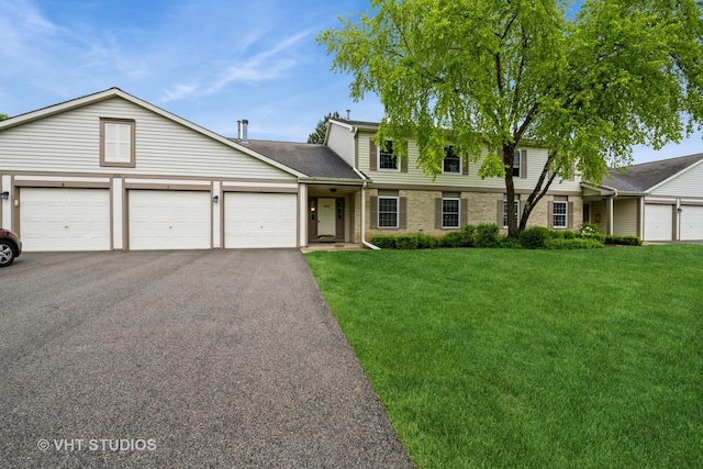 220 Wethington Dr Unit B, Wauconda, IL 60084 - traditional home featuring a front lawn, driveway, an attached garage, brick siding, and a shingled roof