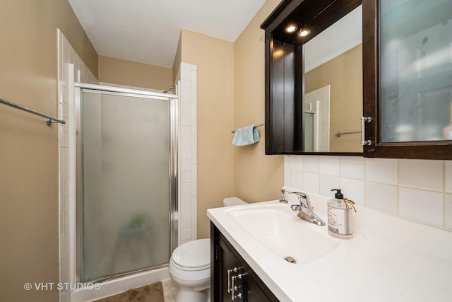 220 Wethington Dr Unit B, Wauconda, IL 60084 - bathroom featuring toilet, a stall shower, vanity, and backsplash