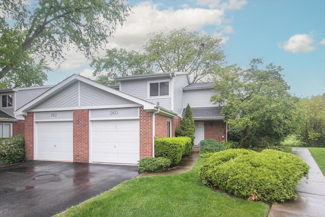 260 W Golfview Ter, Palatine, IL 60067 - view of front of house with a garage, brick siding, and asphalt driveway