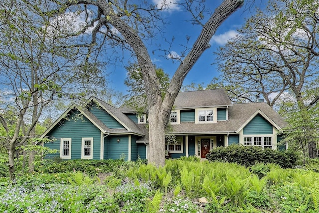 view of front facade featuring roof with shingles