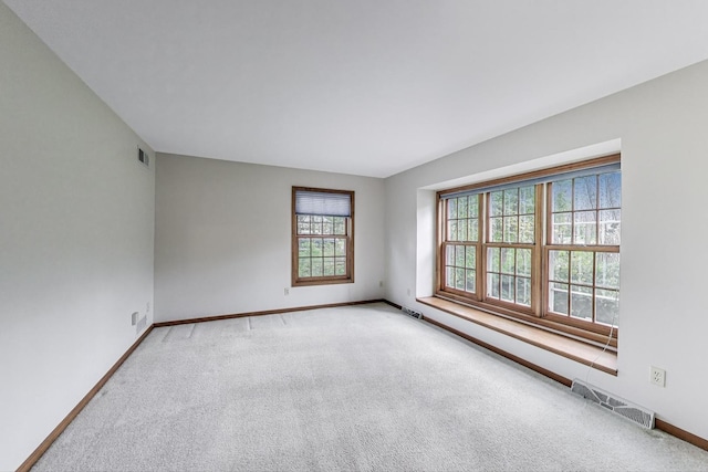 empty room featuring carpet floors and baseboards