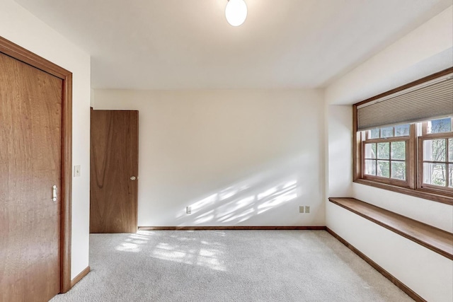empty room with carpet floors and baseboards