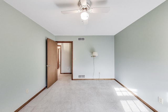 empty room with ceiling fan, carpet flooring, and baseboards