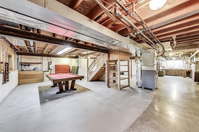 below grade area featuring billiards, stairs, and heating unit
