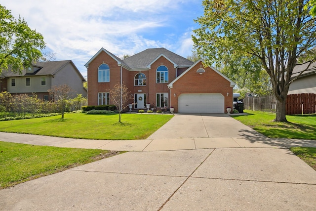 colonial inspired home with brick siding, a garage, and driveway