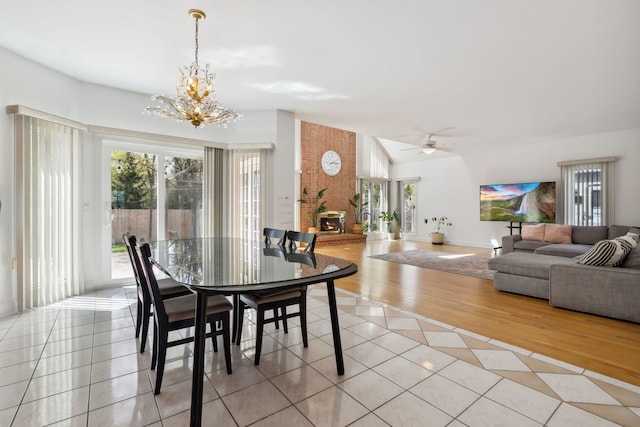 dining area featuring a chandelier, light tile patterned floors, and ceiling fan