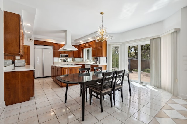 dining space with a chandelier, light tile patterned floors, and recessed lighting